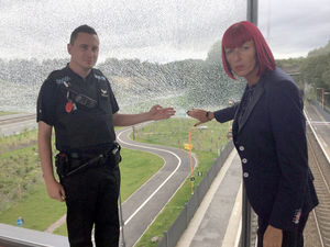 Sergeant Aaron Fortune, of West Mercia Police, and Angie Astley from Telford & Wrekin Council, inspect the damage to one of the glass panels