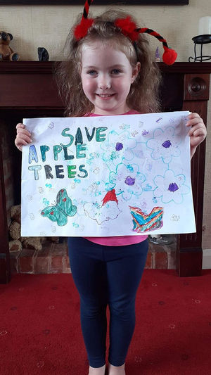 Olivia Cash, four, made a poster in support of Apple Trees