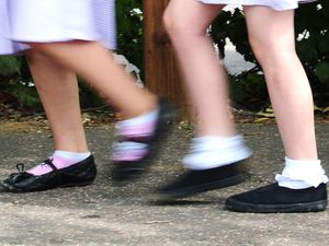 Two girls walking to school