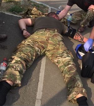 Former soldier David Glanville can be seen on the ground after becoming ill while training