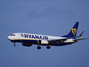 Ryanair plane in the air, surrounded by blue sky