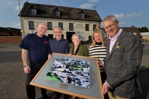 From left, new landlords at the Cock Hotel, Simon Smith and Bill Tolmie, are presented with an aerial photo of the pub by Dorothy Miles, Stephanie Smith and Fraser Miles. Dorothy used to run the pub with her late husband John James-Miles.