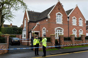 Officers outside the family home on Greyhound Lane in the aftermath of the attack