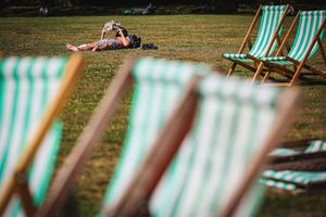 A man reads a book while sunbathing.