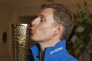 Patrick with the Olympic flame. Pic: Liam McBurney/PA Wire