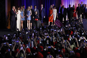Donald Trump arrives on stage at his election night family, flanked by his family