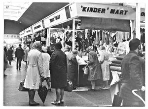 Retail Market, School Street/Salop Street. A children's clothes stall owned by Mr W. J. Legge. The stall is called 'Kinder' Mart. There is a good view of the stall which has a lot of goods on show in October 1971