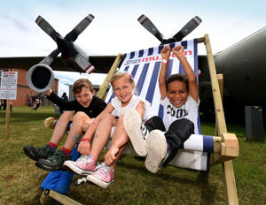  Finley Pinson, aged 7, sister Lacey, 6 and Felix Larkin, 5, try out the giant deckchair