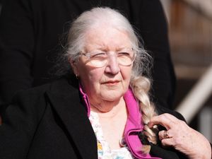 Margaret Caldwell, wearing a black coat with a pink top underneath
