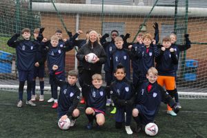 The Sedgley and Gornal under 13s football team with BCRS Business Loans senior business development manager Lynn Wyke
