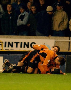 Kennedy is mobbed after scoring the second