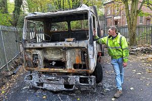 Paul Holloway with the destroyed recovery truck at RTC Recovery in Ketley Bank, Telford