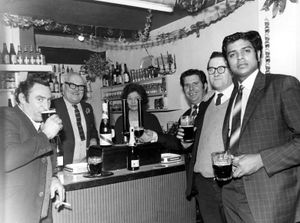 Wayne and Fay hold court as customers enjoy a Christmas drink at the Black Swan in the early 1960s. From left: John Hurdley, Wayne Byer, Fay Byer, Gordon Rickards, Norman Miles, and unknown.