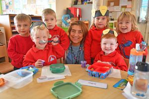 Preschool Manager, Tina Williams, with pupils at one of the tables purchased from last years event