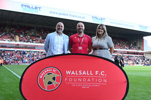 Pallet-Track's Stuart Godman (left) and Freya Sangha (right) with Walsall FC Foundation director Adam Davy