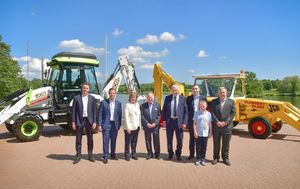 L-R: Flannery Plant Hire MD Patrick Flannery, George Bamford, Mary Flannery, JCB Chairman Anthony Bamford, Pat Flannery Snr, Paul Flannery, Thomas Flannery and Martin Flannery