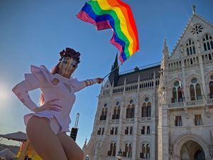 A participant waves a rainbow flag during an LGBT+ rights demonstration in front of the Hungarian parliament building in Budapest