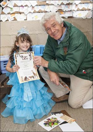 Zoo chief executive Peter Suddock surprises Holly Foley with an adoption for Rapunzel the guinea pig.