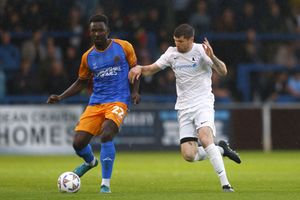 Toto Nsiala of Shrewsbury Town competes with Matty Stenson of AFC Telford United