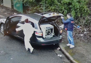 ...before unloading a washing machine from the rear of the car...