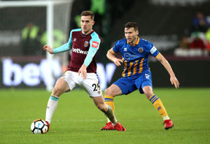 West Ham United's Toni Martinez (left) and Shrewsbury Town's Mat Sadler (right)