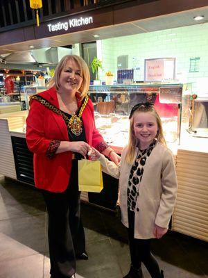 Freya Geraghty receives her goodie bag from the Mayor