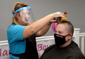 Stylist Clair Vanes cuts off Ellie's hair