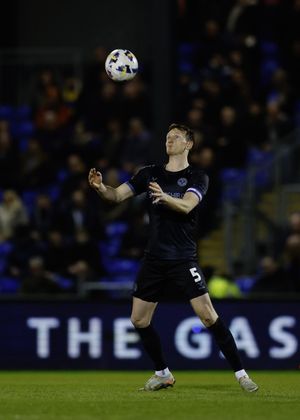 Will Boyle of Shrewsbury Town heads clear against Bristol Rovers