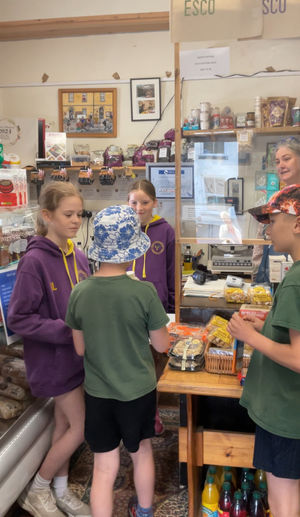 Criw Cymraeg Chairperson, Elise Lingard, and Secretary Eliza Preece photographed modelling Welsh language patterns with fellow Criw Cymraeg members Wynn Hodge, and Elliot Robinson, with Sharon observing closely!