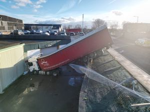 Supporting image for story: Lorry becomes wedged after crashing down steep bank