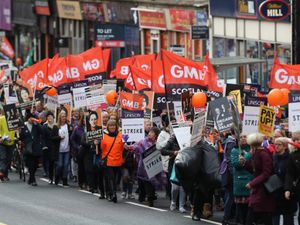 Members of the GMB union march in the street