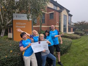 Skydivers JoJo Mejia, Lea Fretwell, and Jessica Bennett and 100 mile bike rider Peter Bentley celebrate their achievements at Allison House in Shrewsbury