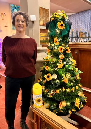 Andrea Childs proudly showing off her 2025 Chrristmas tree
