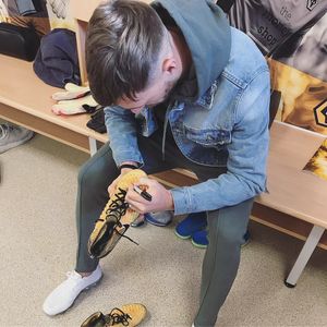 Barry Douglas signs the boots he donated 