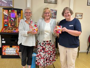 Skittle losers Sheila W and Elizabeth H presented with their sweets by Cynthia Shepperd, PRFWI Board