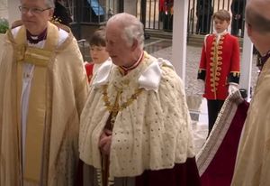 Prince George standing behind King Charles Picture: BBC