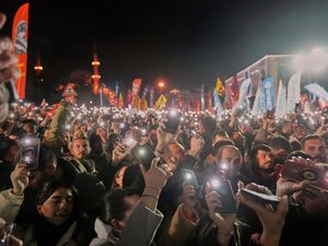 People raise their mobile phones as they gather outside the City Hall in Istanbul to protest against the arrest of Istanbul mayor Ekrem Imamoglu