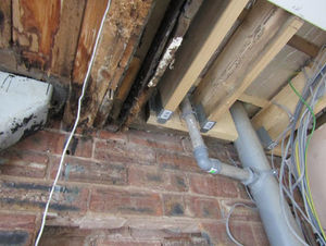 Exposed wiring and wooden beams 