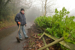 John Russon surveys the damage to his fence