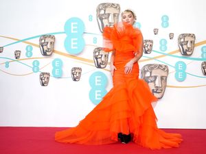 Supporting image for story: Florence Pugh’s bright orange dress leads charge of colourful outfits at Baftas