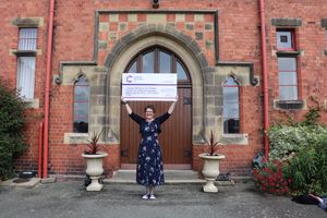 Bells Lewers with cheque for Cancer Research UK after Ellesmere College concert 
