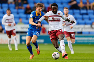 Tom Bayliss of Shrewsbury Town and Emmanuel Monthe of Northampton Town (AMA)