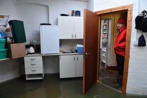 Martin Lunt views the damage in his flooded pharmacy, Lunts Pharmacies, in Shrewsbury
