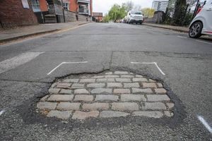 Pothole exposing cobbled streets on St Vincent Street in Birmingham