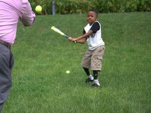 Supporting image for story: First child to undergo double hand transplant fulfils his dream of swinging a baseball bat