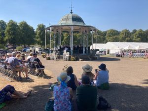 People seeking shade at the Flower Show.