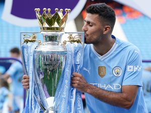 Manchester City’s Rodri kisses the Premier League trophy