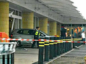 Supporting image for story: Car reverses into shop window after crash