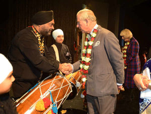 The Prince of Wales, speaks with Harjit Singh, teacher with the Azaad Dhol Group, at the Royal School, Wolverhampton