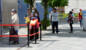 Customers queuing to enter the market